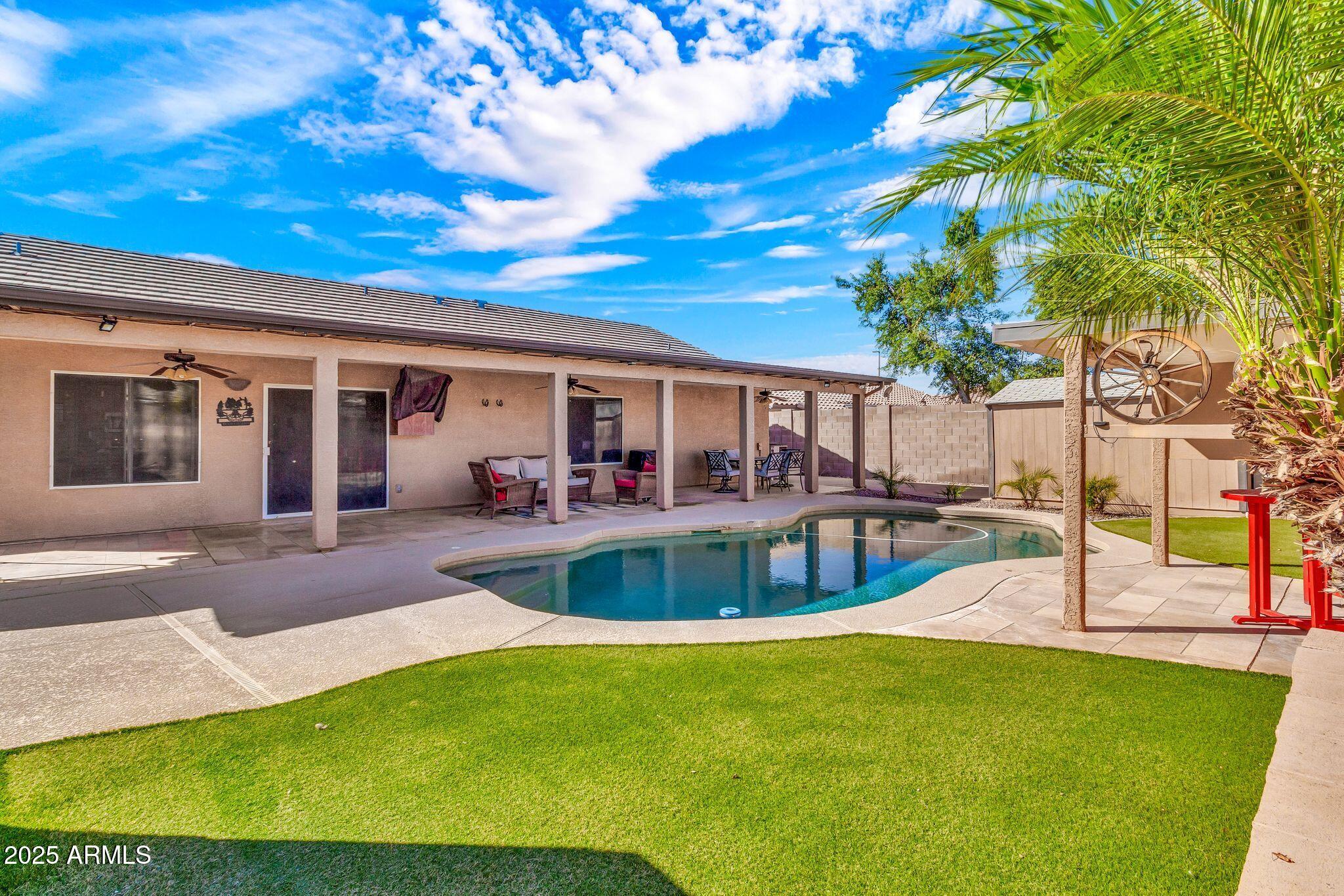 3048 East Erie Street Gilbert, AZ 85295 - Photo 38 of 44 a view of a house with swimming pool and sitting area