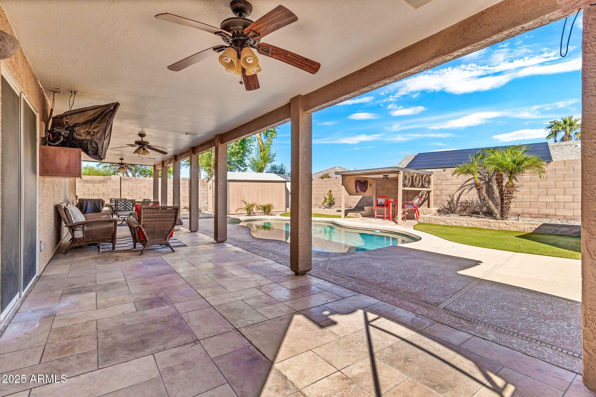 3048 East Erie Street Gilbert, AZ 85295 - Photo 41 of 44 a view of a porch with a table and chairs