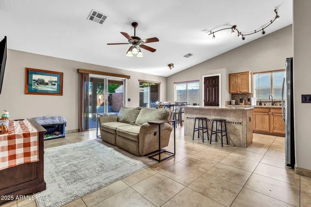 a living room with furniture and a view of kitchen
