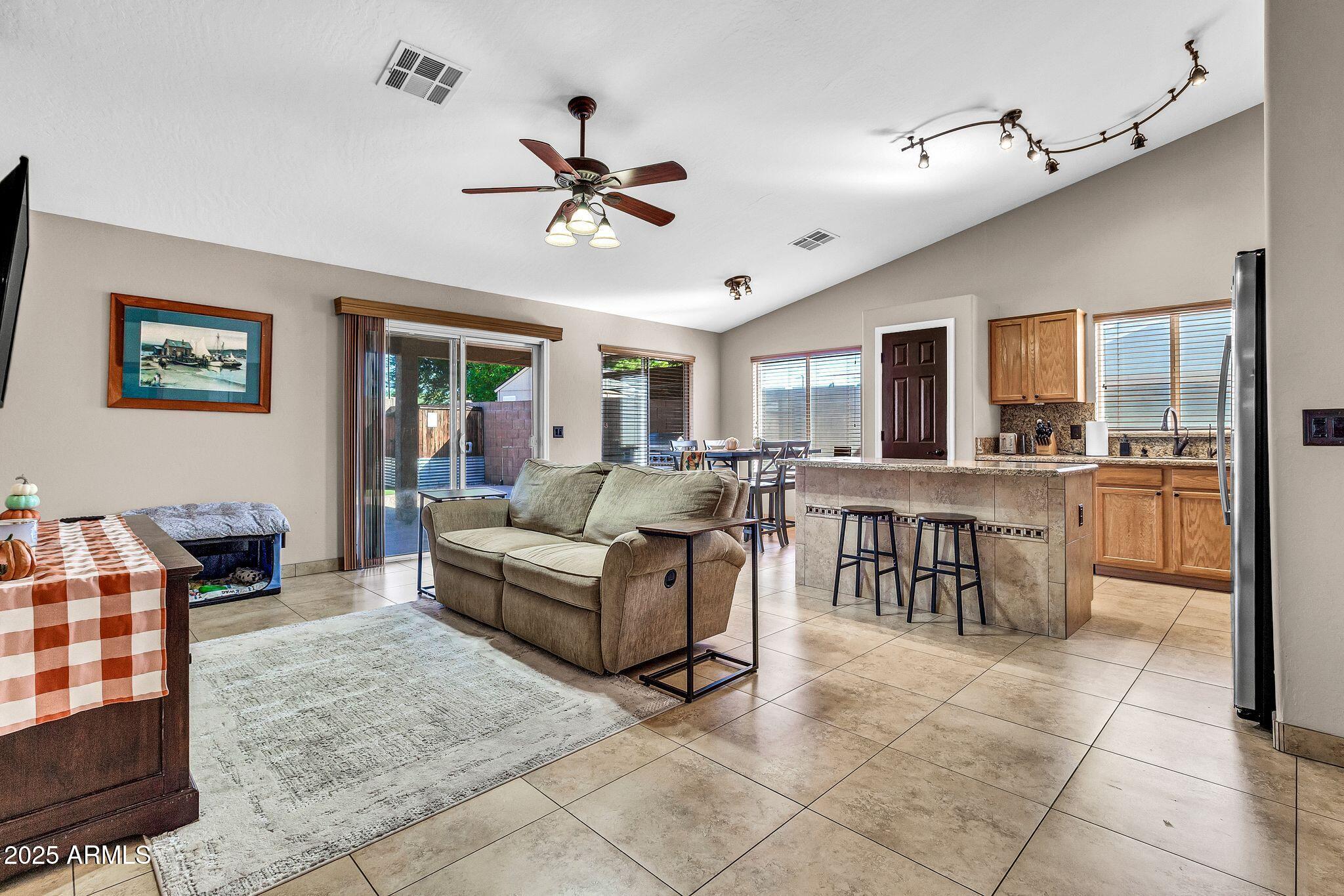 3048 East Erie Street Gilbert, AZ 85295 - Photo 8 of 44 a living room with furniture and a view of kitchen
