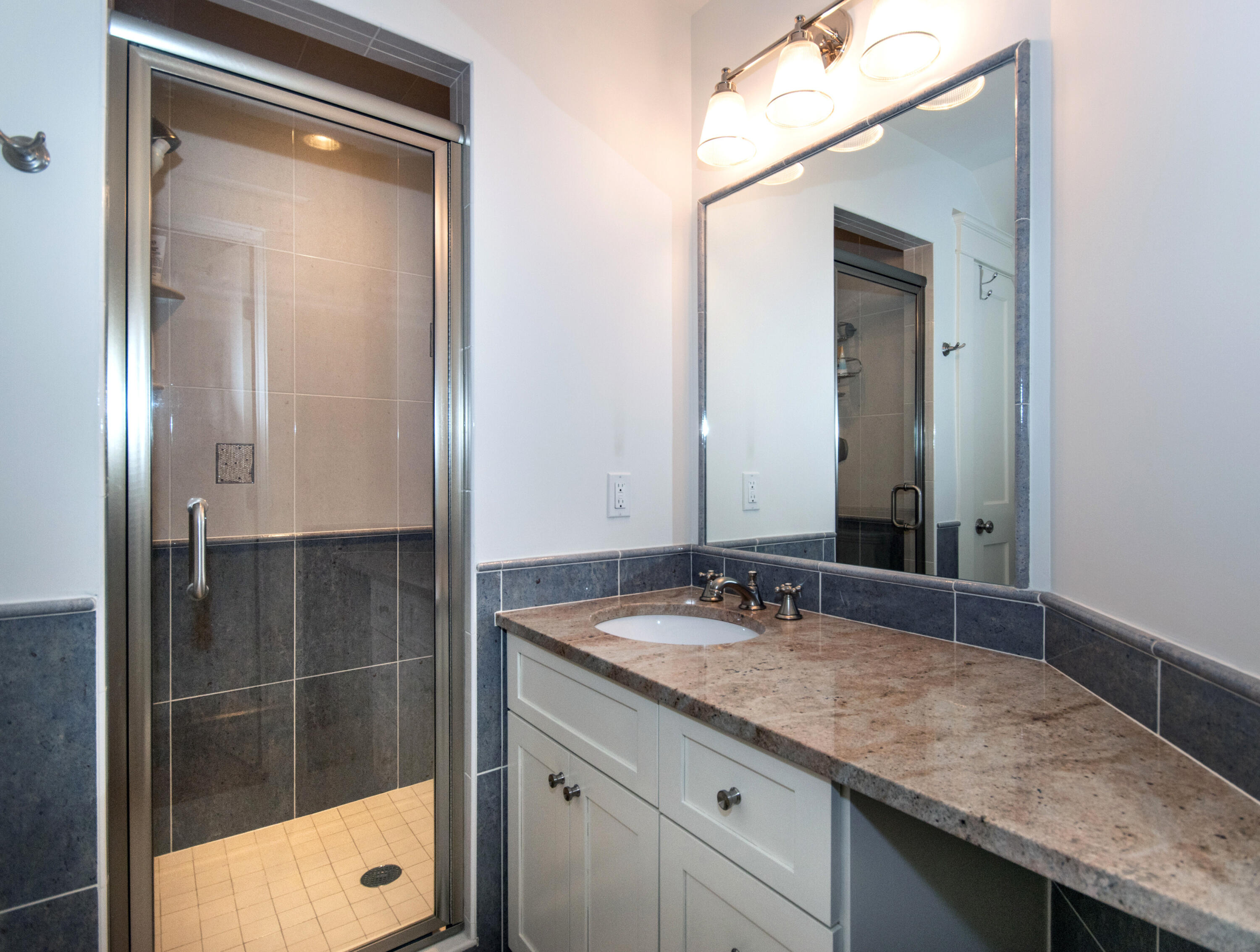 10 Wakeman Road Darien, CT 06820 - Photo 18 of 38 a bathroom with a granite countertop sink a mirror and a shower