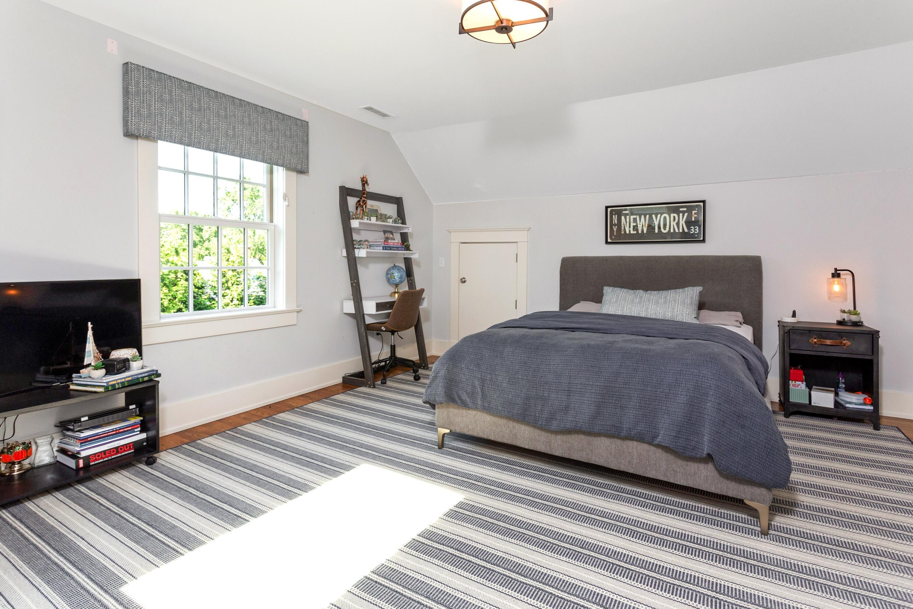 10 Wakeman Road Darien, CT 06820 - Photo 21 of 38 a bedroom with a bed wooden floor and a flat tv screen