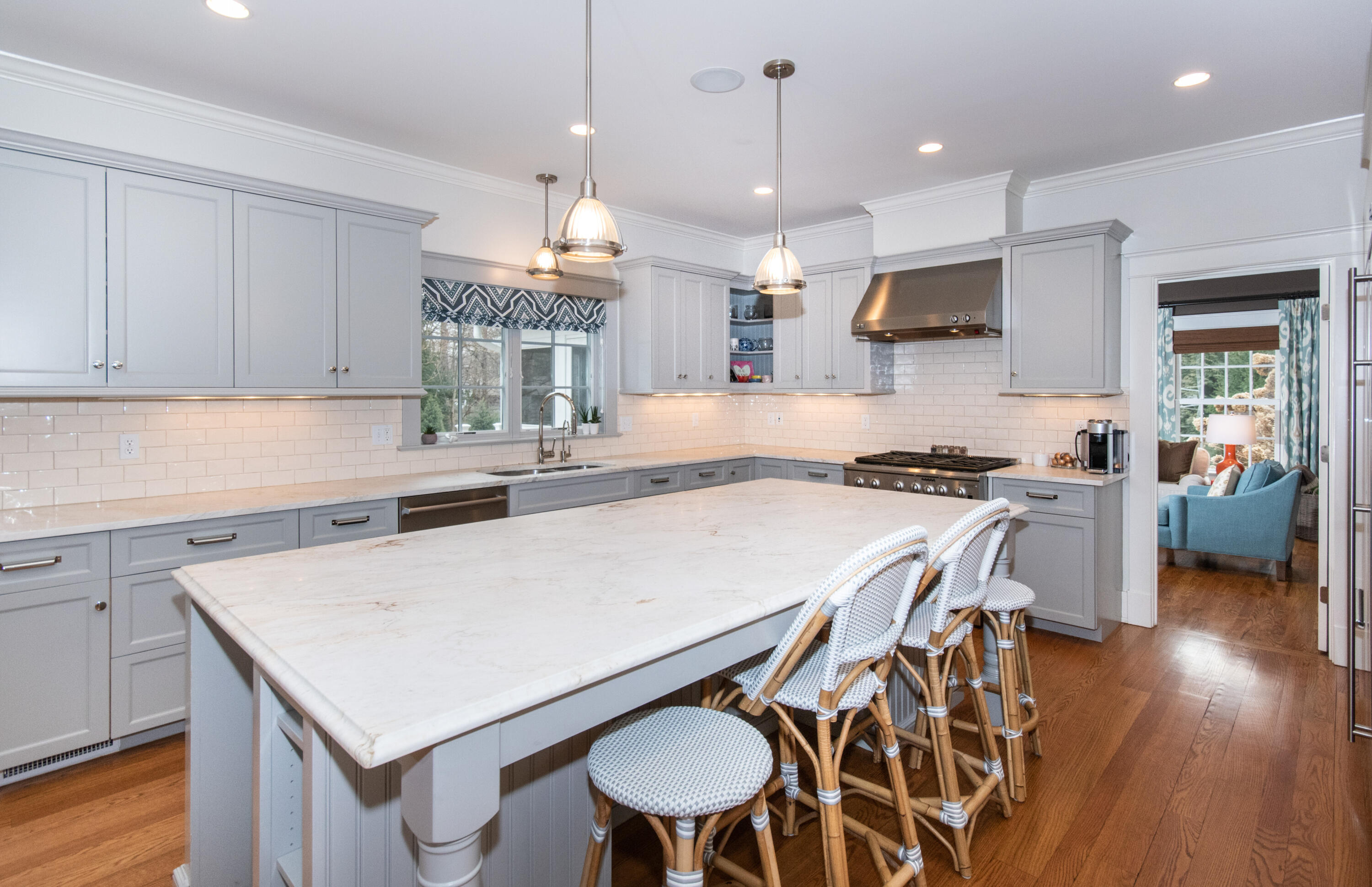 10 Wakeman Road Darien, CT 06820 - Photo 6 of 38 a kitchen with a table chairs a sink dishwasher stove and cabinets with wooden floor