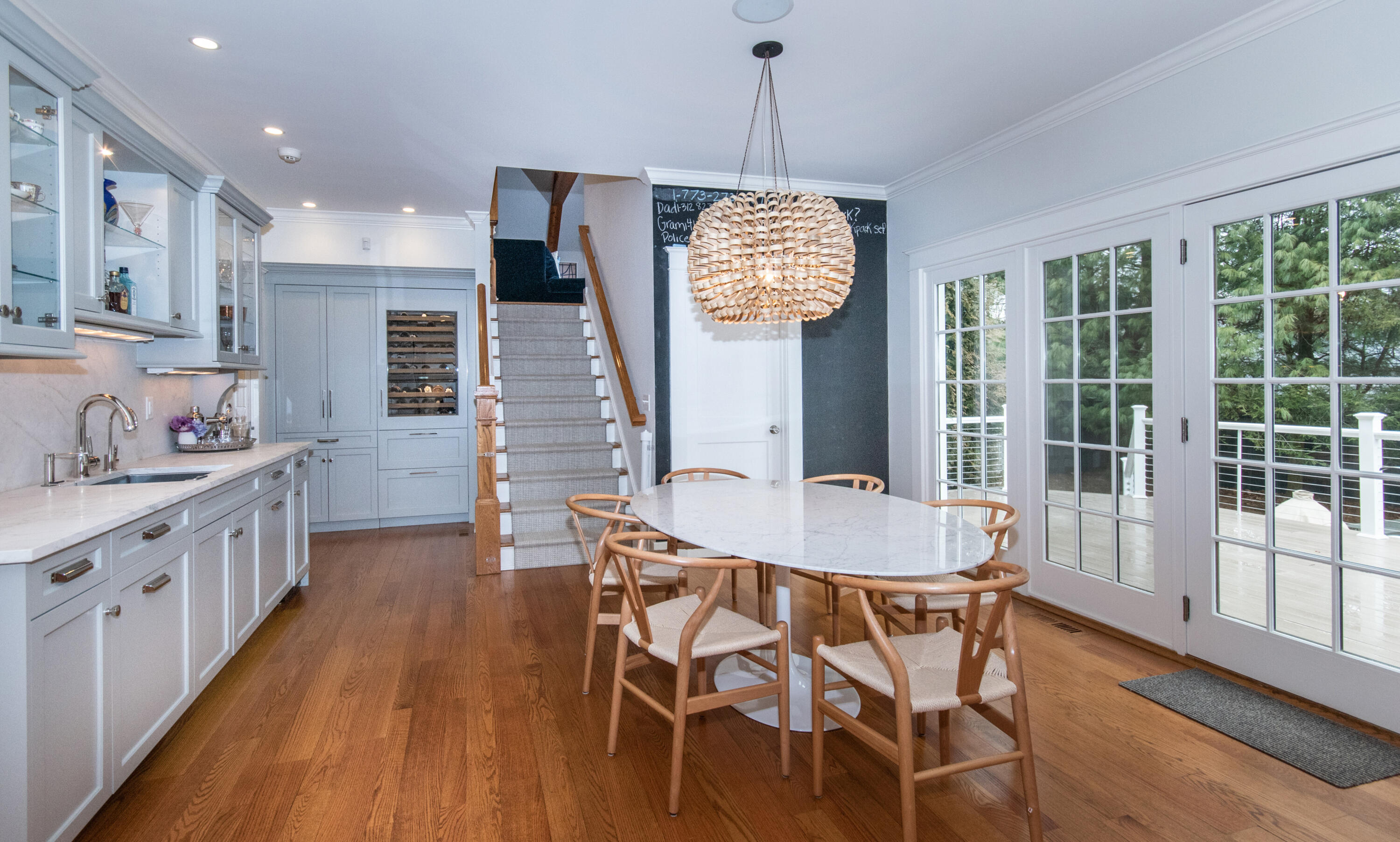 10 Wakeman Road Darien, CT 06820 - Photo 8 of 38 a dining room with wooden floor a chandelier a wooden table and chairs