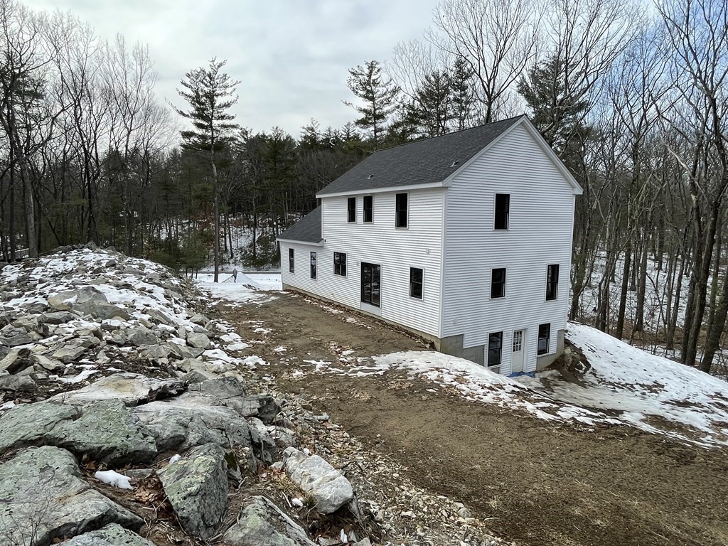 49 Old Shirley Road Harvard, MA 01451 - Photo 2 of 10 a view of a white house with a yard covered in snow