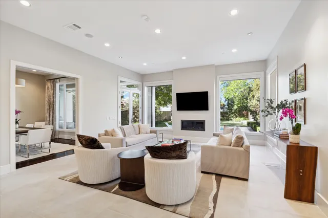 a living room with fireplace furniture and a flat screen tv