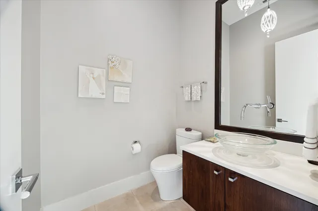 a bathroom with a granite countertop sink a toilet and a mirror