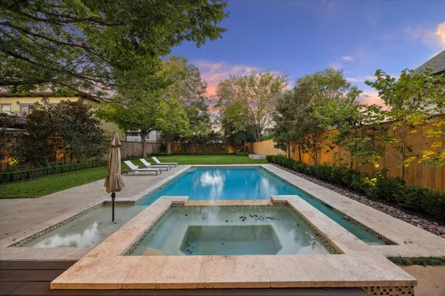 a view of a swimming pool with a yard