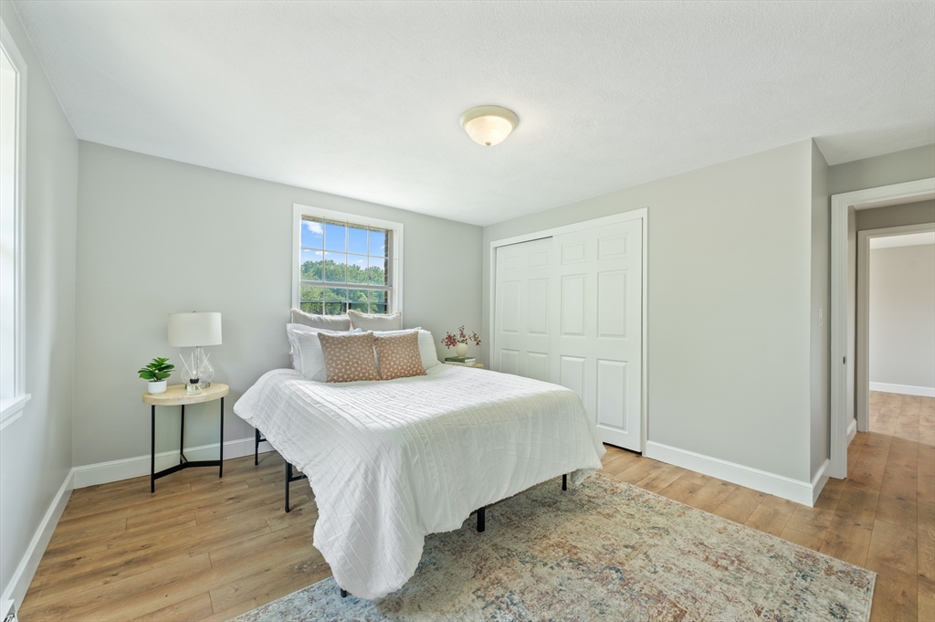 7 Walker Road, Unit 12 North Andover, MA 01845 - Photo 3 of 20 a bedroom with a bed and a table