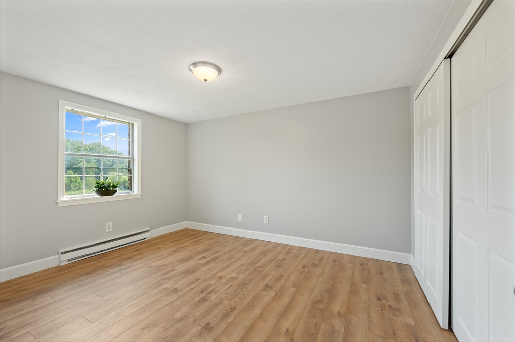 7 Walker Road, Unit 12 North Andover, MA 01845 - Photo 5 of 20 wooden floor in an empty room with a window