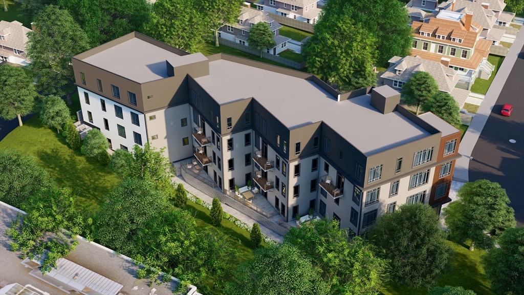 45 Bartlett Crescent, Unit 101 Brookline, MA 02446 - Photo 2 of 5 an aerial view of a house with balcony and trees al around