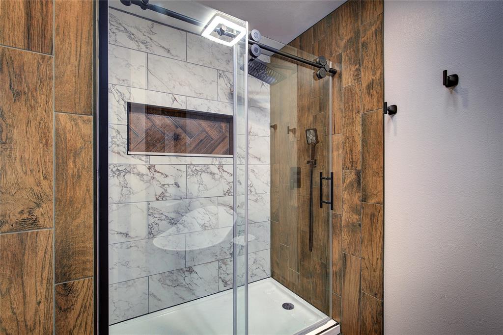 2027 Park Springs Road Sulphur Springs, TX 75482 - Photo 23 of 39 a bathroom with a shower and a mirror