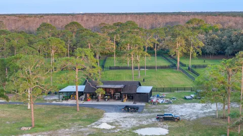 a view of a patio with table and chairs under an umbrella