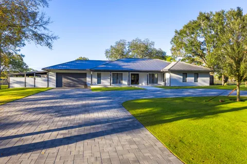 a front view of a house with a swimming pool