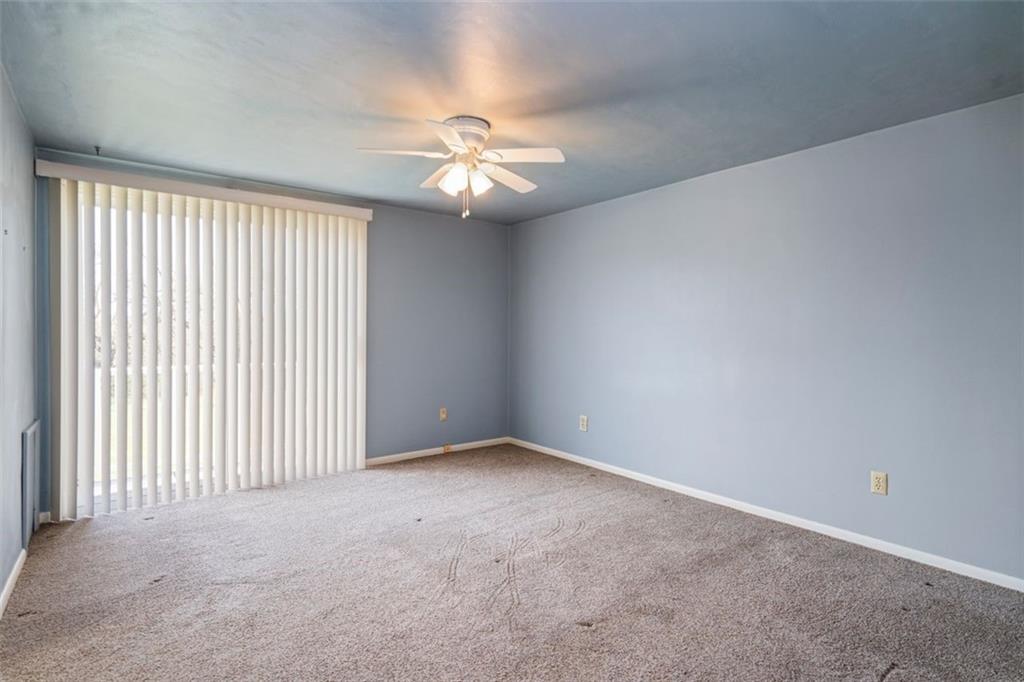 413 Pittsburgh Street New Derry, PA 15671 - Photo 13 of 23 an empty room with a window and a ceiling fan