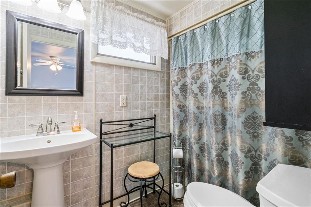 413 Pittsburgh Street New Derry, PA 15671 - Photo 14 of 23 a bathroom with a sink toilet and shower curtain