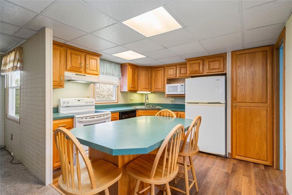 413 Pittsburgh Street New Derry, PA 15671 - Photo 7 of 23 a kitchen with stainless steel appliances granite countertop a refrigerator a sink a stove and island with wooden floor