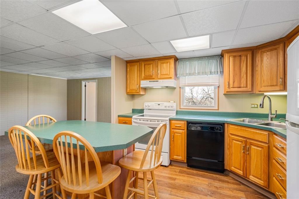 413 Pittsburgh Street New Derry, PA 15671 - Photo 8 of 23 a kitchen with stainless steel appliances granite countertop a sink a stove a table and chairs