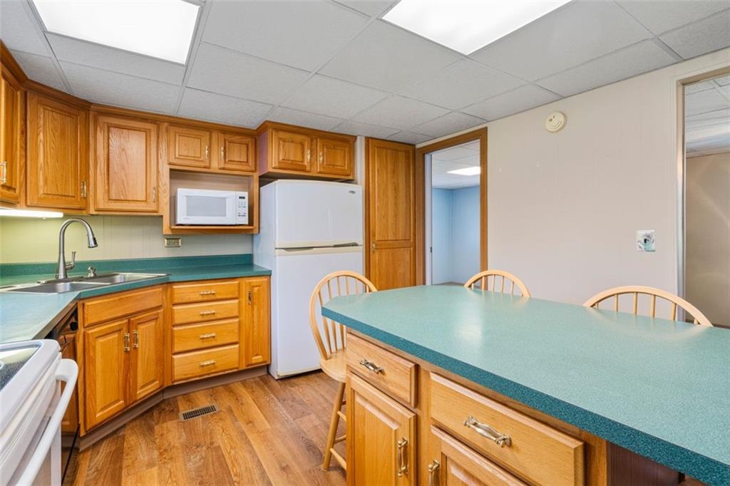 413 Pittsburgh Street New Derry, PA 15671 - Photo 9 of 23 a kitchen with stainless steel appliances granite countertop a sink a stove and a refrigerator