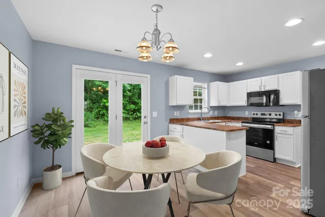 a kitchen with a table and chairs in it