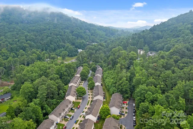 an aerial view of residential houses with outdoor space