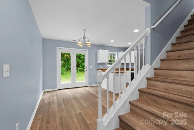 a view of entryway and hall with wooden floor