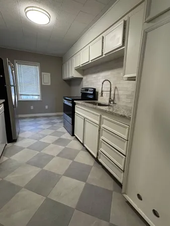 a kitchen with stainless steel appliances granite countertop a sink and cabinets