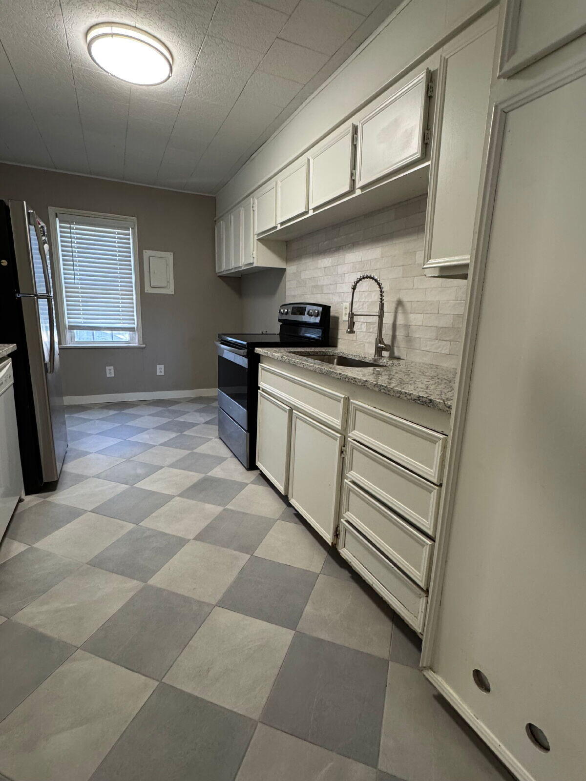 2514 29th Street Lubbock, TX 79410 - Photo 5 of 8 a kitchen with stainless steel appliances granite countertop a sink and cabinets