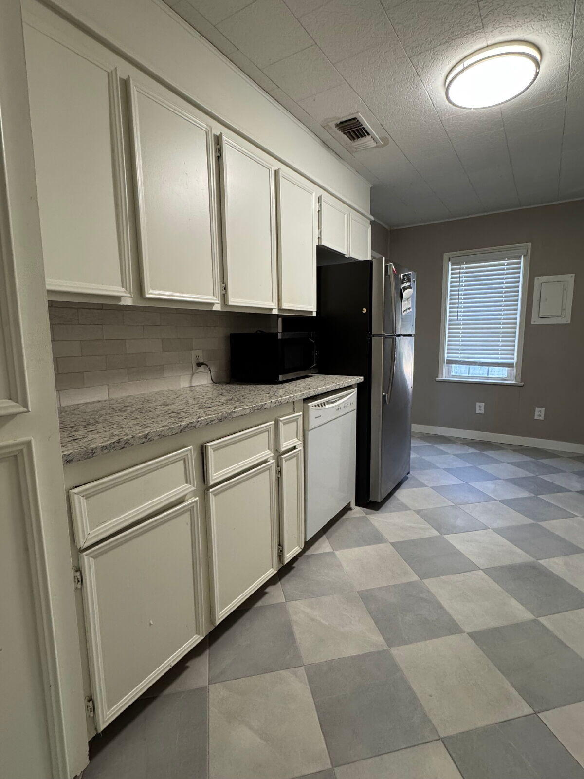2514 29th Street Lubbock, TX 79410 - Photo 6 of 8 a kitchen with stainless steel appliances granite countertop a stove a sink and a microwave