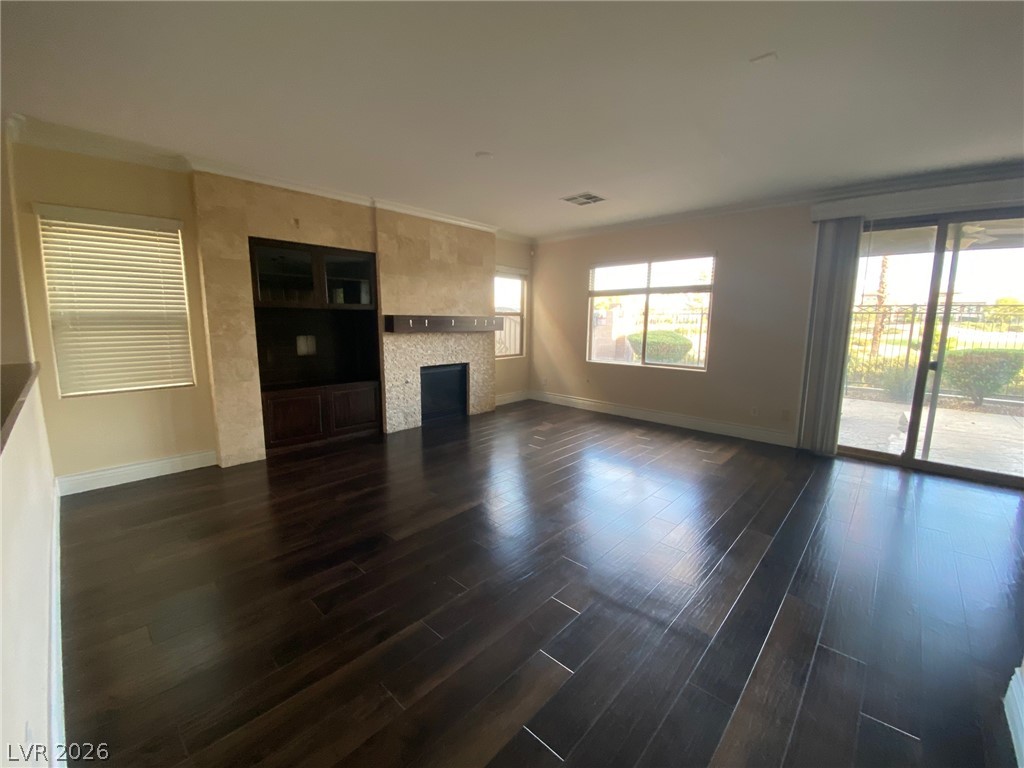 159 Tall Ruff Drive Las Vegas, NV 89148 - Photo 31 of 31 Rich dark wood flooring reflects natural light streaming through glass sliding doors.