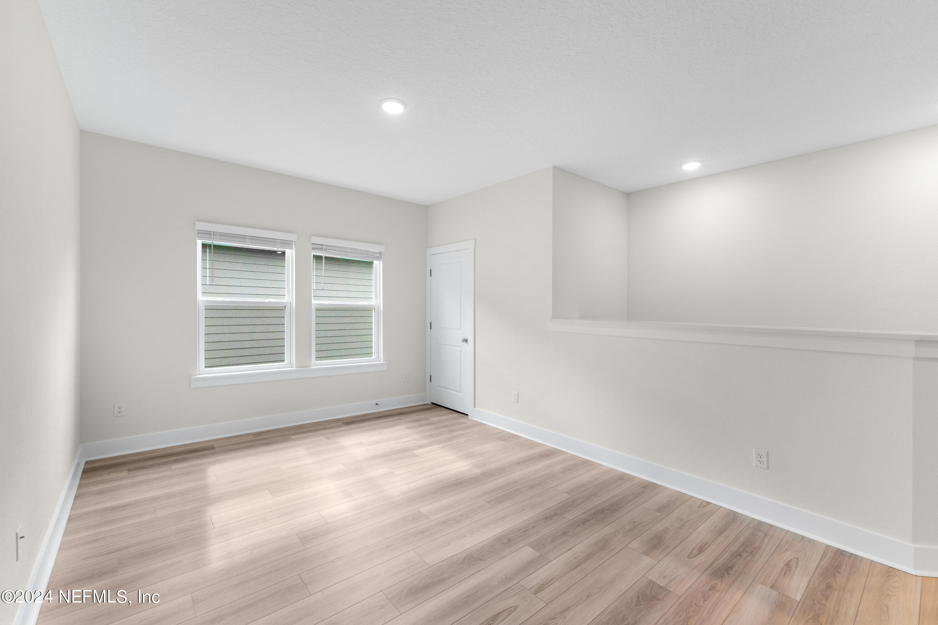 9973 Element Road Jacksonville, FL 32256 - Photo 12 of 18 a view of an empty room with wooden floor and a window