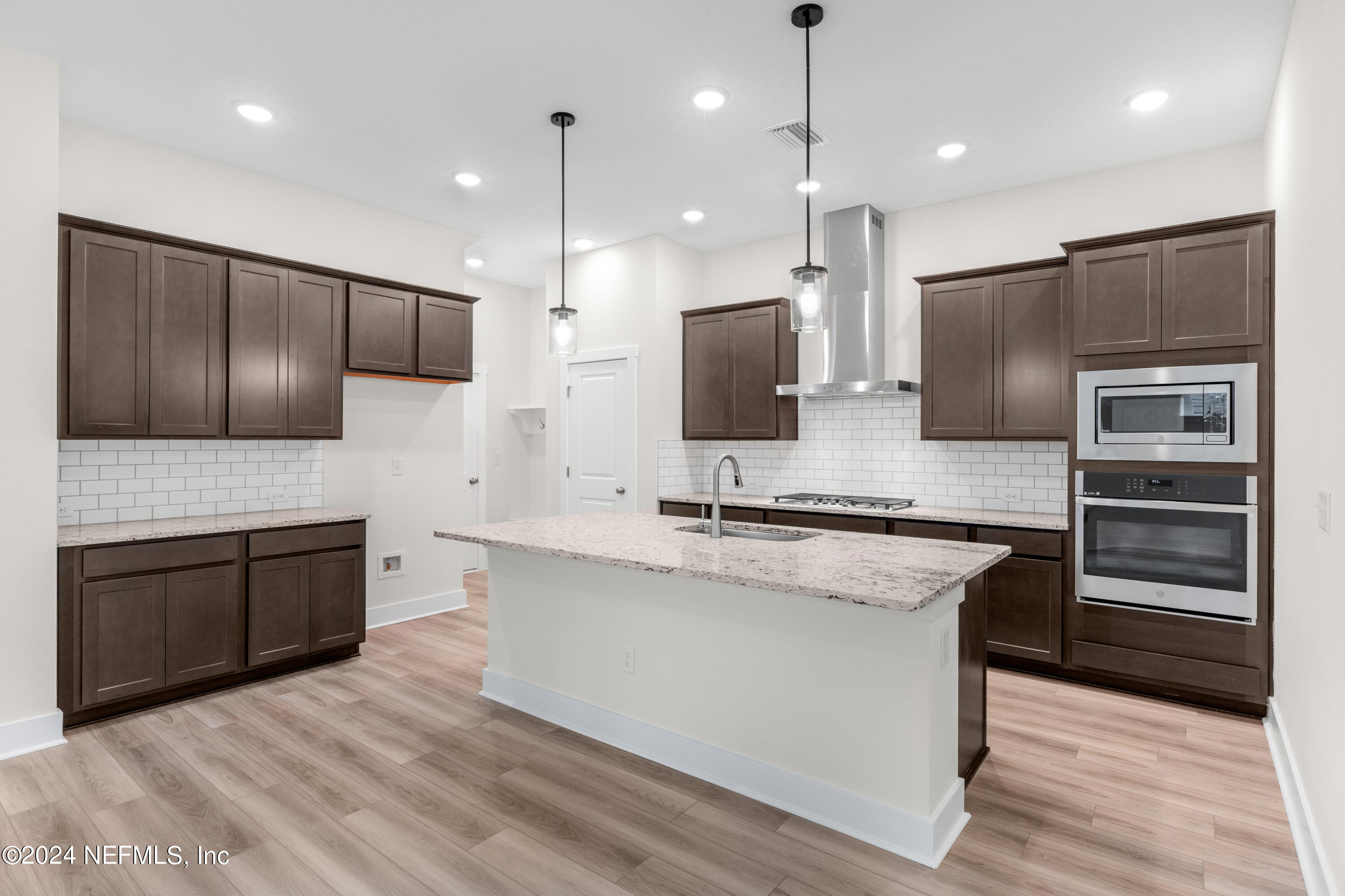 9973 Element Road Jacksonville, FL 32256 - Photo 4 of 18 a large kitchen with kitchen island a large counter top stainless steel appliances and cabinets