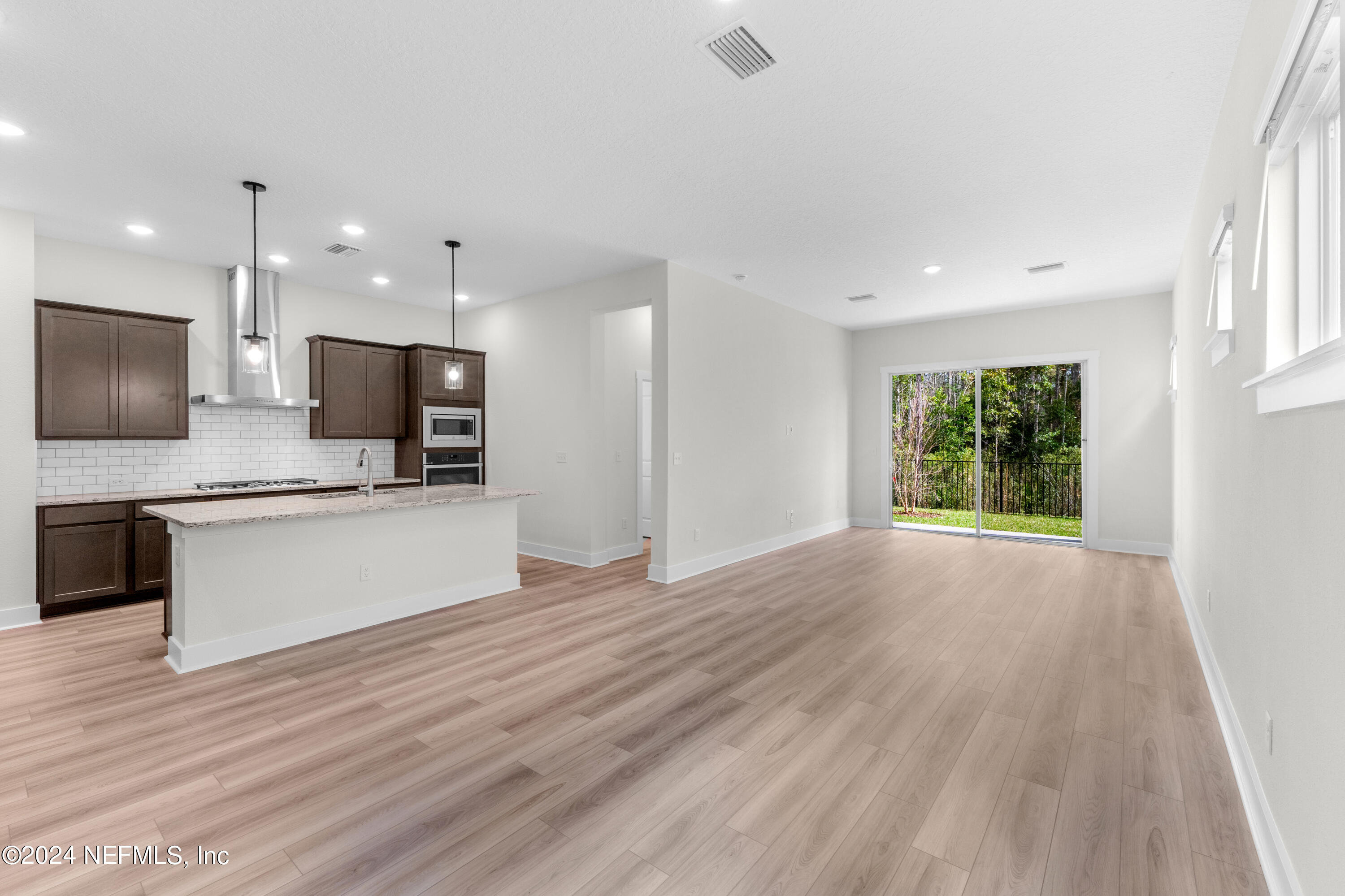 9973 Element Road Jacksonville, FL 32256 - Photo 7 of 18 a view of a kitchen with a sink and a stove top oven