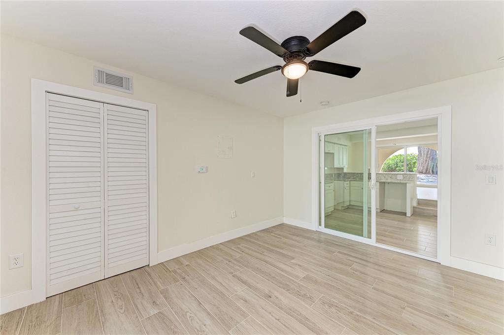 101 73rd Street, Unit 1 Holmes Beach, FL 34217 - Photo 13 of 50 an empty room with wooden floor and windows