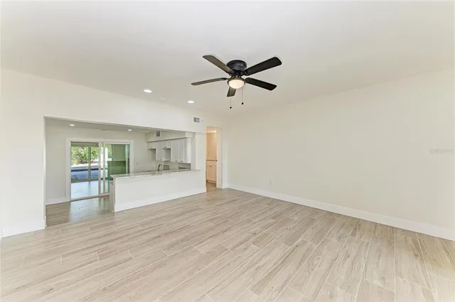 a view of empty room with wooden floor