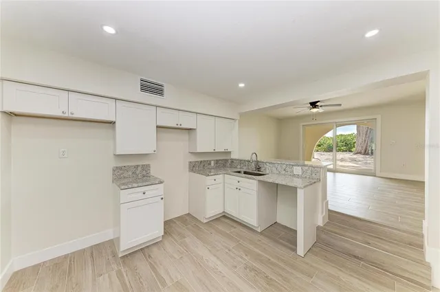 a kitchen with a sink stove and refrigerator