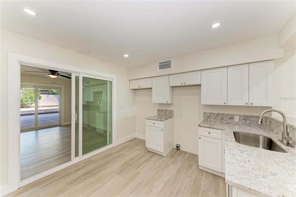 101 73rd Street, Unit 1 Holmes Beach, FL 34217 - Photo 22 of 50 a kitchen that has a sink and a refrigerator
