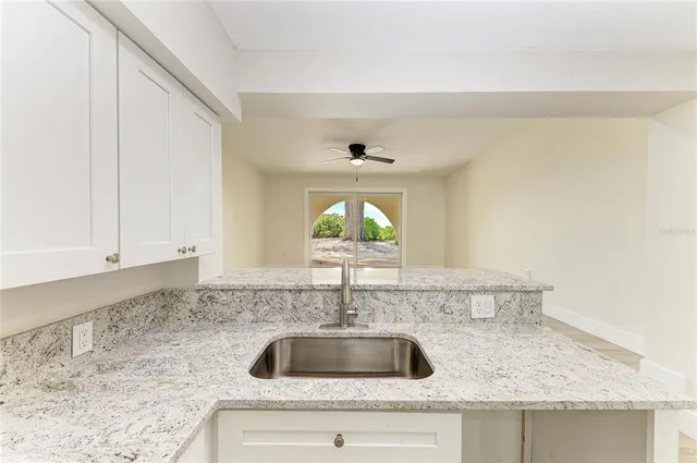 a view of kitchen island wooden cabinets and refrigerator