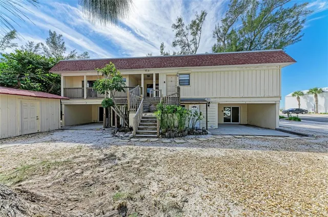 a view of a house with a patio and a yard