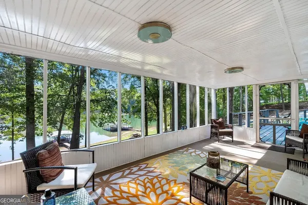 a living room with furniture and a floor to ceiling window
