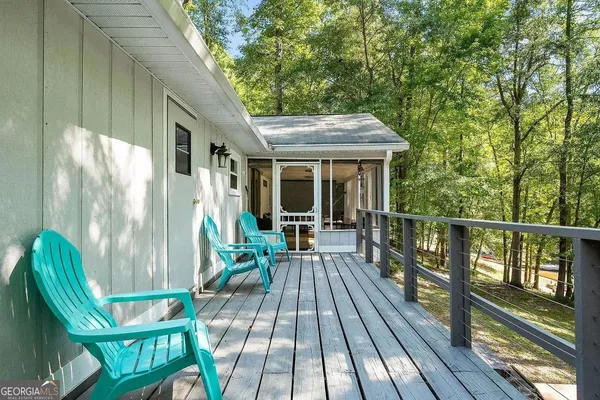 a view of balcony with chairs and wooden fence