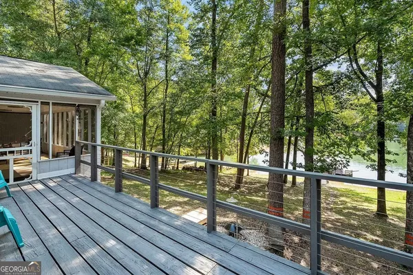 a view of a wooden deck with chairs