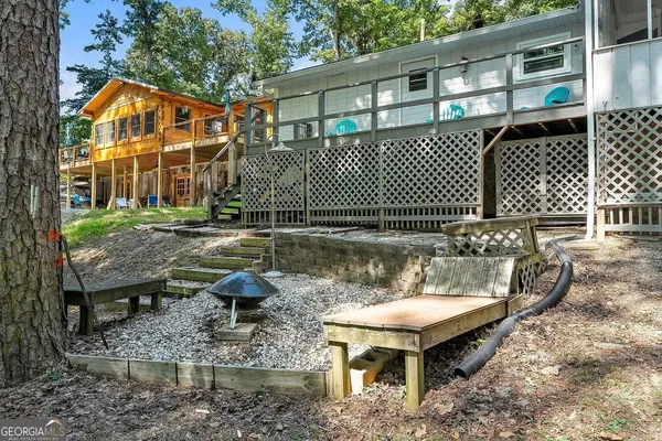 a view of a house with backyard and sitting area