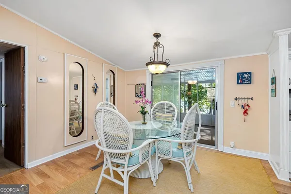 a dining room with furniture a chandelier and window