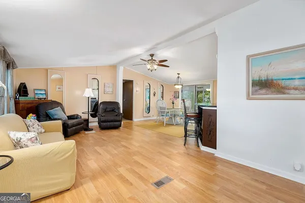 a living room with furniture and a wooden floor