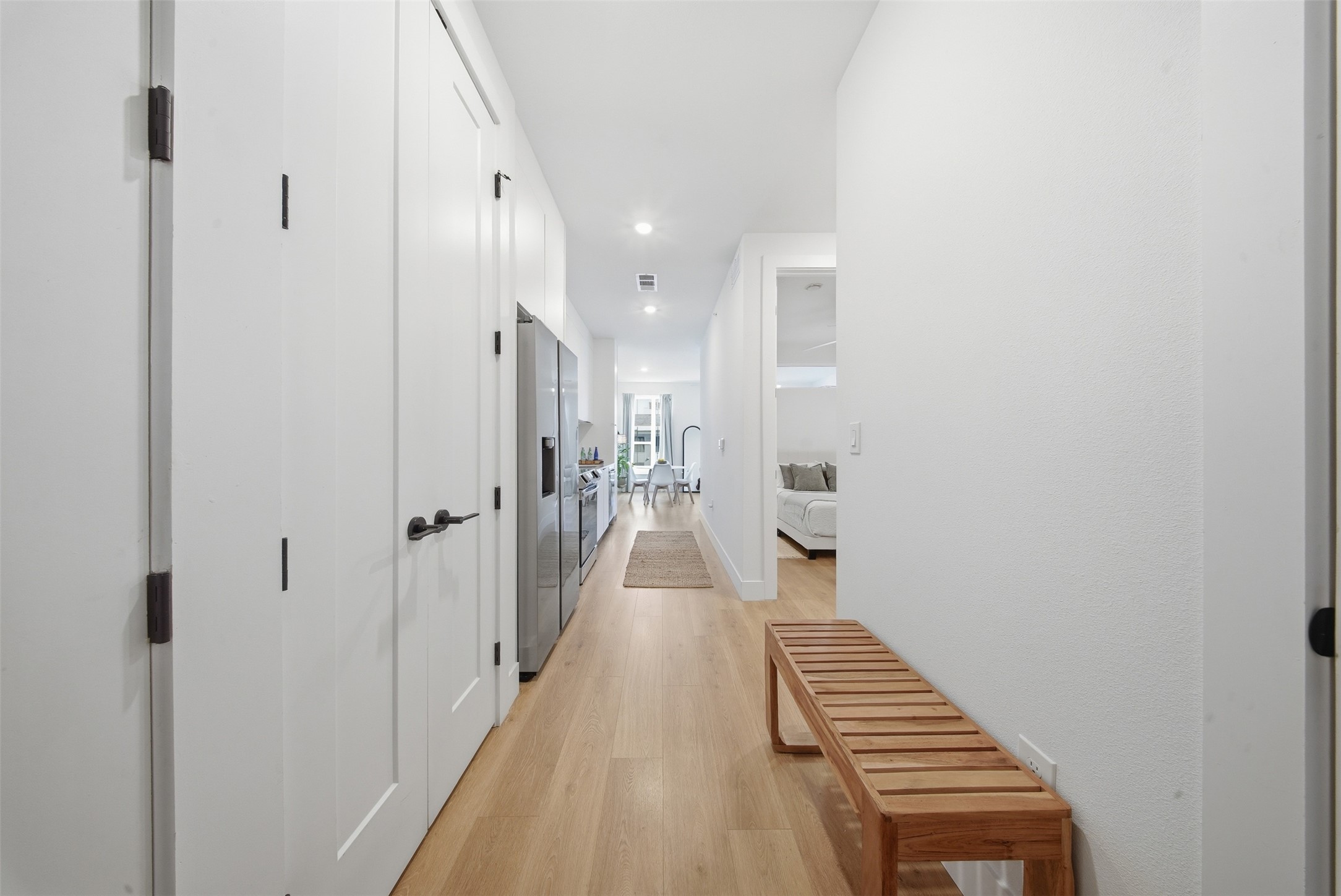 1701 Simond Avenue, Unit 615 Austin, TX 78723 - Photo 11 of 25 a view of a hallway with wooden floor and a bathroom