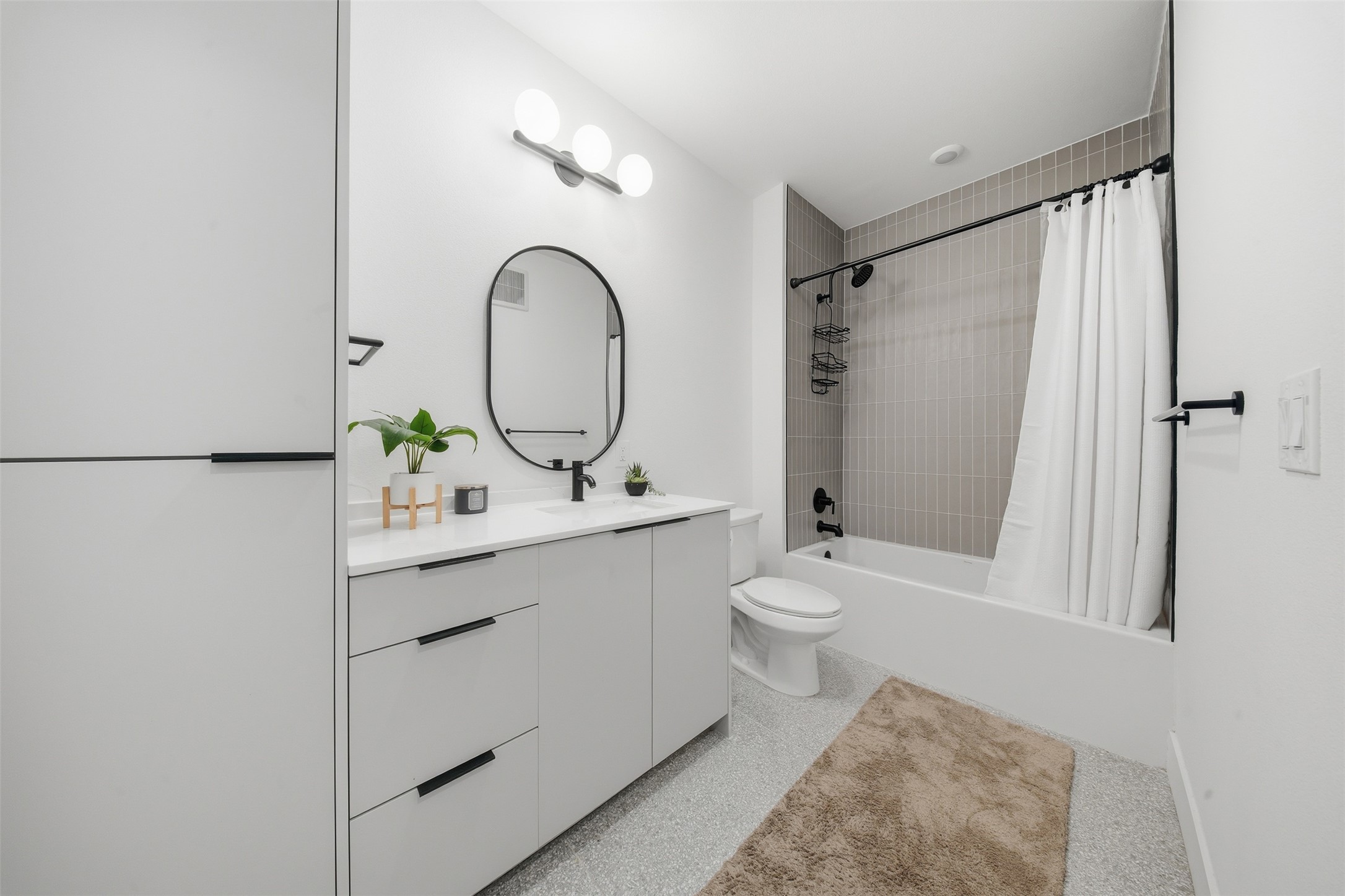 1701 Simond Avenue, Unit 615 Austin, TX 78723 - Photo 14 of 25 a bathroom with a sink toilet and shower