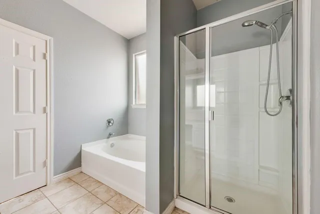 a bathroom with a bathtub and a shower