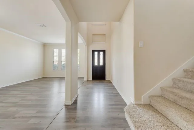 wooden floor in a hall with an entryway of a house