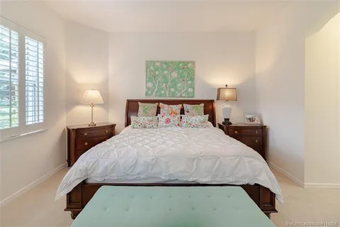 a bedroom with a bed and a night stand